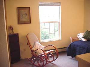 Another view of the bedroom, with one bed put away under the other.