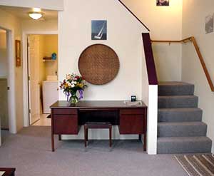 Looking from the wall back toward the stairs and desk