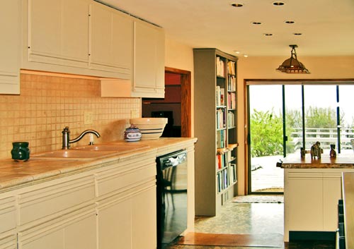 Looking thorugh the kitchen to the dining nook and deck