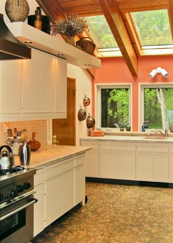 Looking beyond the stove to the sink under the skylights